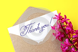 Love envelope and letter with written words thank you with pink hyacinth flowers