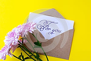 Love envelope and letter with written words for you with pink chrysanthemum flowers