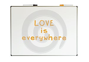 Love is everywhere, written on a whiteboard