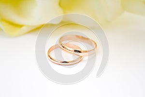 love, family, celebration, ceremony concept -wedding symbols two golden rings with callas white flowers