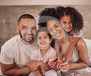 Love, family and hug portrait in bedroom with Mexican parents and young kids in pyjamas. Cheerful and happy latino