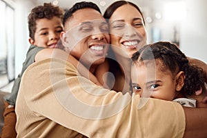 Love, family and hug portrait in living room with Mexican parents and young kids in house. Care and happy latino man