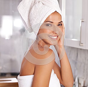 Love that feeling after a shower. Portrait of a beautiful young woman standing in the bathroom in a towel.