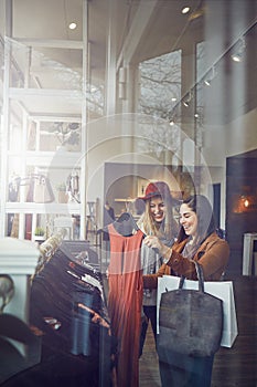 This is love at first sight. two best friends out shopping in a clothing store.