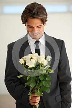 Love, flowers and happy man with bouquet, gift or surprise for date, anniversary or romance. Roses, smile and male