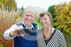 Love in focus. Happy senior couple bonding to each other and making selfie