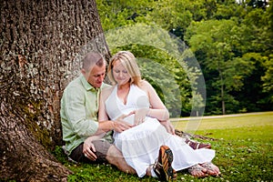 Love: Future Parents Sitting Beneath a Tree