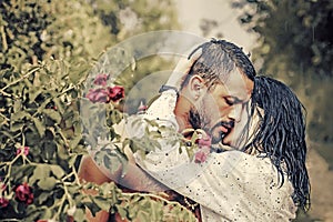 Love in the garden. Passionate couple in the garden hugging. photo