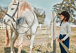 Love, girl and horse in field, countryside and bonding for hobby, summer vacation and training. Female child, kid or pet