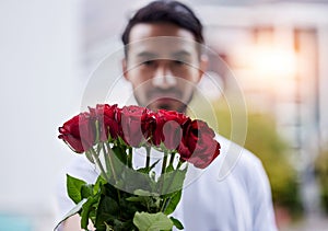 Love, giving and man with bouquet of roses for date, romance and hope for valentines day. Confession, romantic gift and