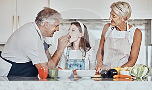 Love, grandparents or girl cooking or eating as a happy family in house kitchen with organic vegetables for dinner