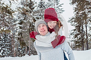 Love - Happy couple having fun smiling happy laughing together on romantic holidays. Young man giving piggyback ride to