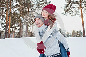 Love - Happy couple having fun smiling happy laughing together on romantic holidays. Young man giving piggyback ride to
