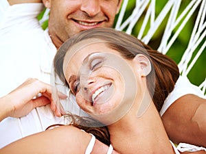 Love, happy couple or relax on hammock in nature, peace or lazy vacation in summer on tropical island. Young man, woman