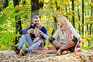 This is love. happy woman and bearded man drink hot wine. couple in love relax in autumn forest with tea or coffee