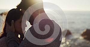 Love, happy and young couple at beach sharing a beautiful moment on sunset date. Man and woman enjoying quiet intimate