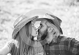 Love and harmony. Bearded cowboy in hat kissing adorable girlfriend. Couple in love. Romantic kiss. Happy couple ranch