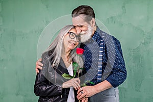 Love has no age. Romantic senior couple celebrating Saint Valentine`s Day. Beautiful woman and handsome man enjoying