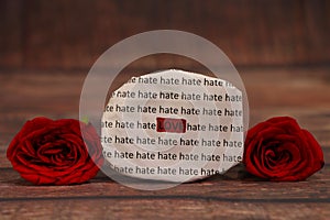Love Hate text with red roses.