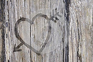 Love heart and arrow graffiti carved into wood