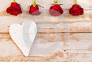 Love heart background with red roses on vintage wood for Valentine or Mothers Day card