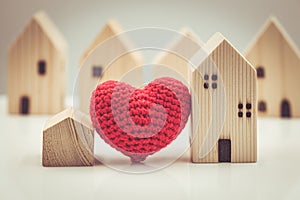 Love heart between big and small house model for stay at home love together and healthy community concept