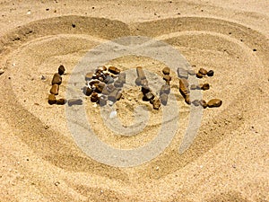 LOVE and HEART figures on a sand