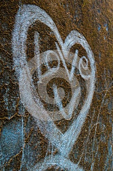 A love heart graffiti made by scrapping a concrete wall. India