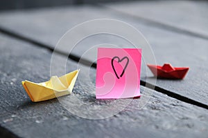 Love heart. love concept. Drawing on the tag and paper boat