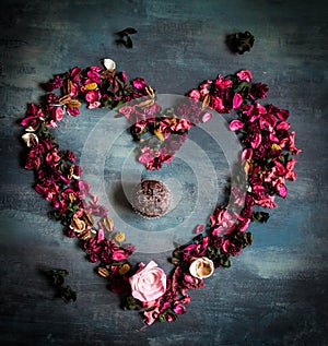 Love heart made of flower decoration with muffin