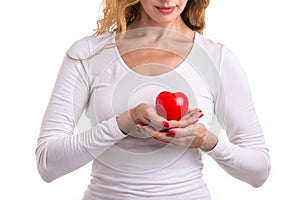 Love heart, protect and healthcare concept : Caucasian woman holding red heart on her chest and heart position isolated on white
