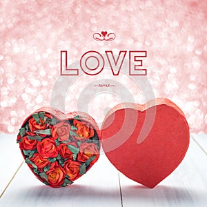 Love with Heart shape box with red roses inside on white wood ta