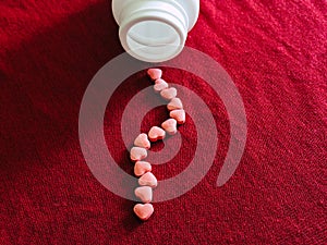 Heart medicine in red cloth background. Valentines day photo