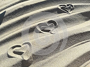 Love hearts drawn on the sand of the beach