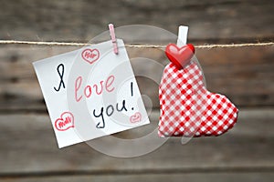 Love hearts hanging on rope on the grey wooden background