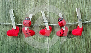 Love hearts hanging on rope on a wooden background. Love concept. Valentine`s day card. copy spaces