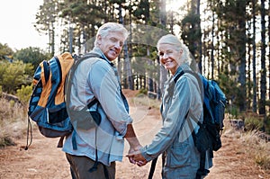 Love, hiking and portrait of old couple holding hands on nature walk in mountain forest in Canada. Travel, senior man