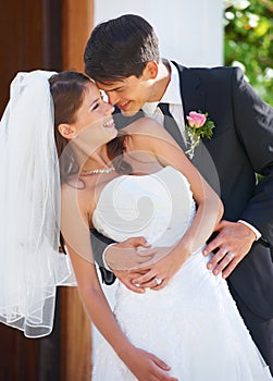 The love of his life. A handsome groom dipping his gorgeous bride and looking into her eyes.