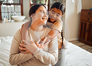 Love, hug and mother and daughter on a bed, bonding and sharing a sweet moment in their home together. Family, happy and