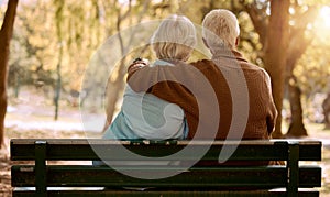 Love, hug and old couple in a park on a bench for a calm, peaceful or romantic summer marriage anniversary date. Nature