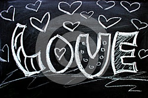 Love. I love you. Message of love. The inscription on the blackboard with chalk. Valentine`s day theme. Dark grunge texture backgr