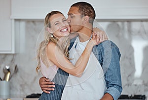Love, interracial and couple kiss in kitchen, happiness and loving together for relationship. Romance, man and woman