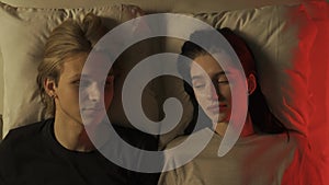 Love intimate relationship concepts. Top view loving couple having romantic time in bedroom. Man and woman lying in bed