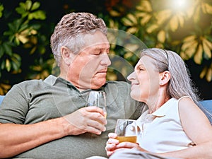 Love, juice and senior couple talking while relaxing outdoor in the garden at their home in summer. Happy, conversation