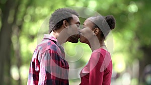 Love, kiss and happy with black couple in park for romance, happiness and summer break. Bonding, affection and hug with