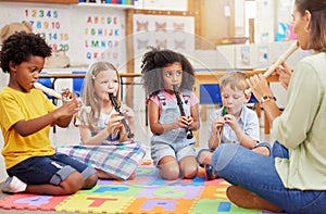 We love learning about musical instruments. Shot of children learning about musical instruments in class.