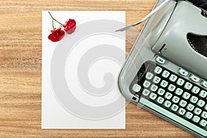 Love letter. Desk with blank paper, retro typewriter and red roses and petals
