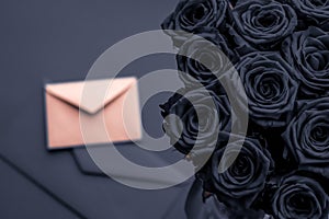 Love letter and flowers delivery on Valentines Day, luxury bouquet of roses and card on charcoal background for romantic holiday