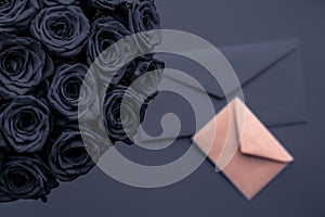 Love letter and flowers delivery on Valentines Day, luxury bouquet of roses and card on charcoal background for romantic holiday