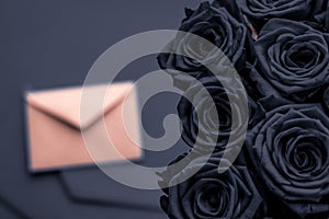 Love letter and flowers delivery on Valentines Day, luxury bouquet of roses and card on charcoal background for romantic holiday